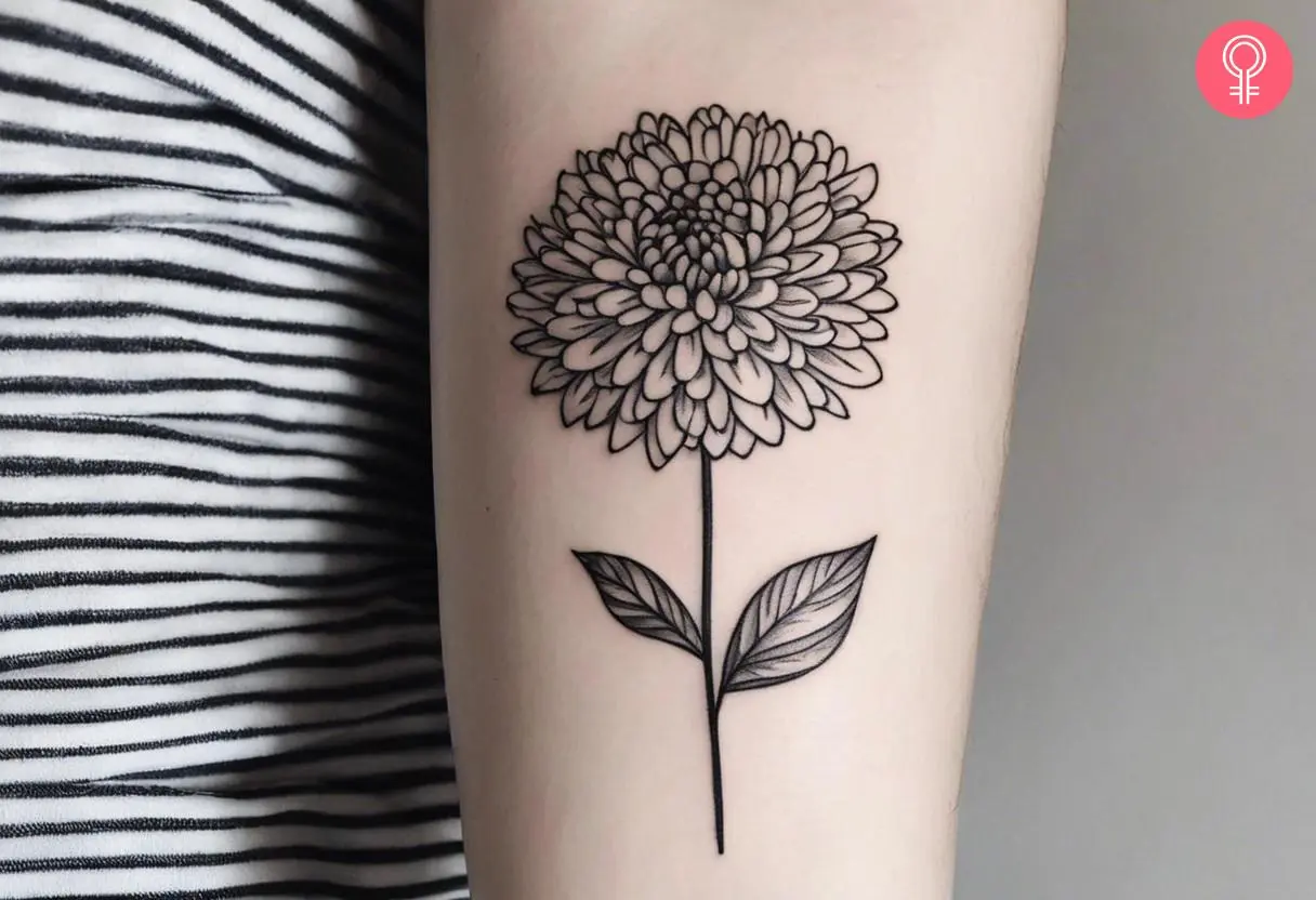 A black and white chrysanthemum inked on the forearm