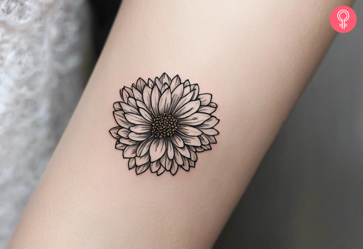 A black and white chrysanthemum inked on the forearm