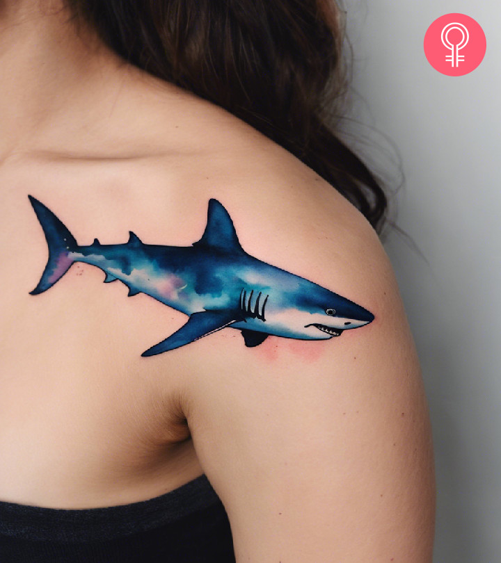 A watercolor shark tattoo on the shoulder