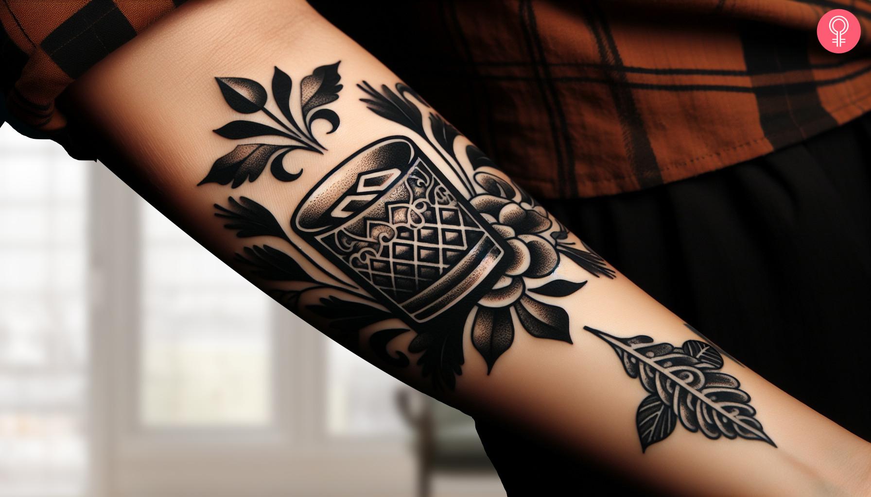 Traditional black ink whiskey tattoo on the forearm