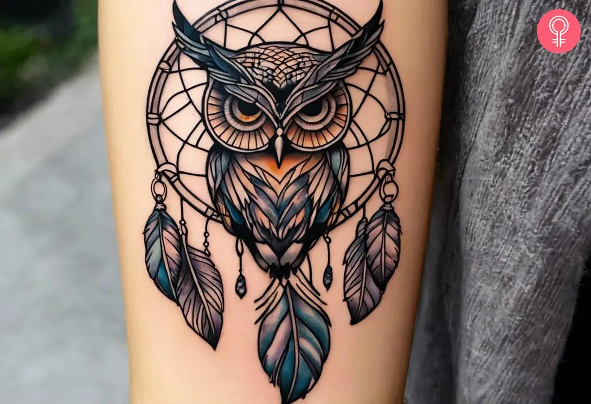 A traditional owl dreamcatcher tattoo on the forearm