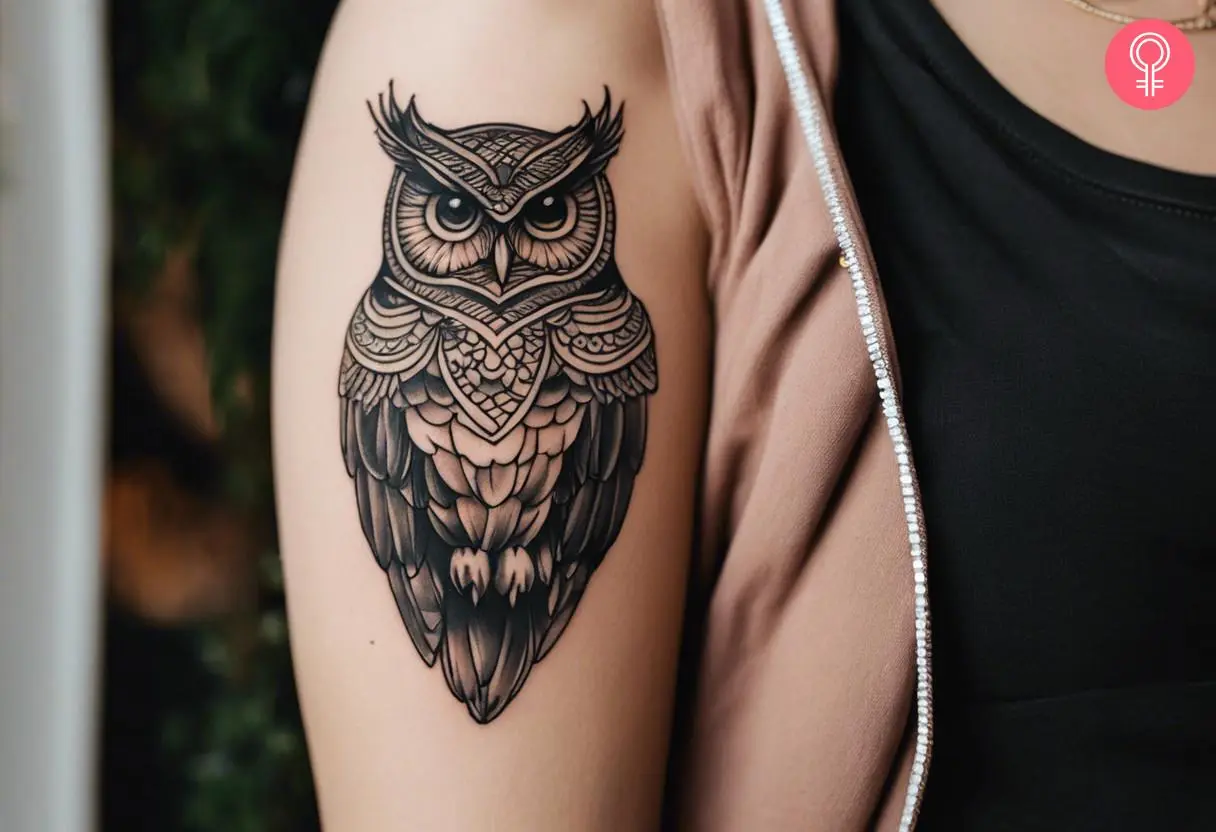 Owl wisdom tattoo on the upper arm