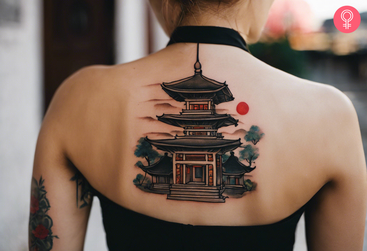 Aesthetic pagoda tattoo on the upper back of a woman