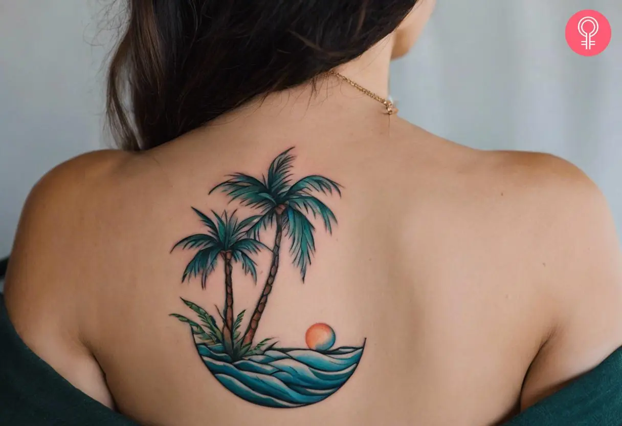 A colored tattoo with blue waves, orange sun, and green palm trees on the back