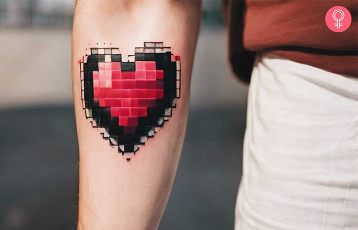 Pixel heart tattoo on a woman’s arm