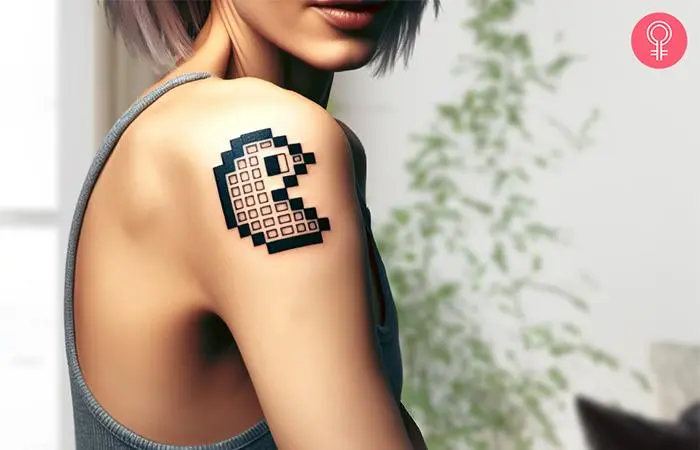 Pacman pixel tattoo on a woman’s arm