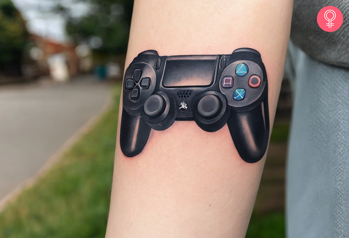 A PlayStation controller tattoo on a woman’s arm