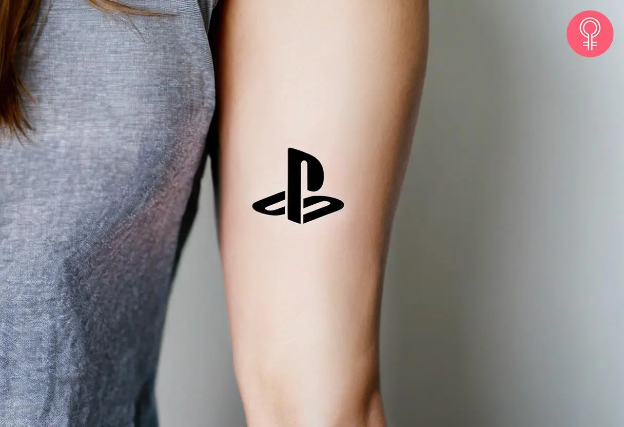 A PlayStation logo tattoo on a woman’s arm