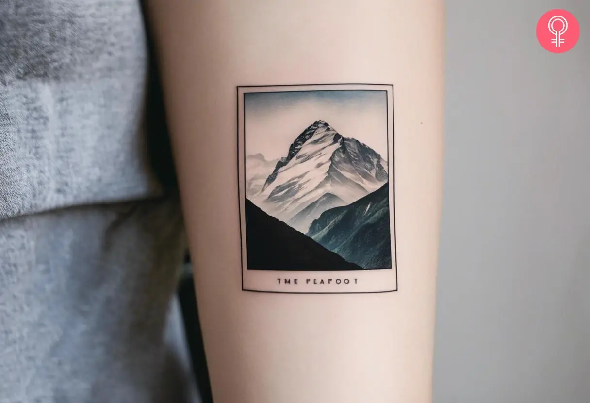 Polaroid mountains tattoo inside arm of a woman