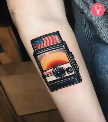 A black-and-white Chevvy car tattoo on the forearm