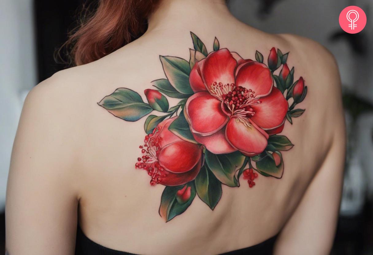 Pomegranate flower tattoo on a woman's back