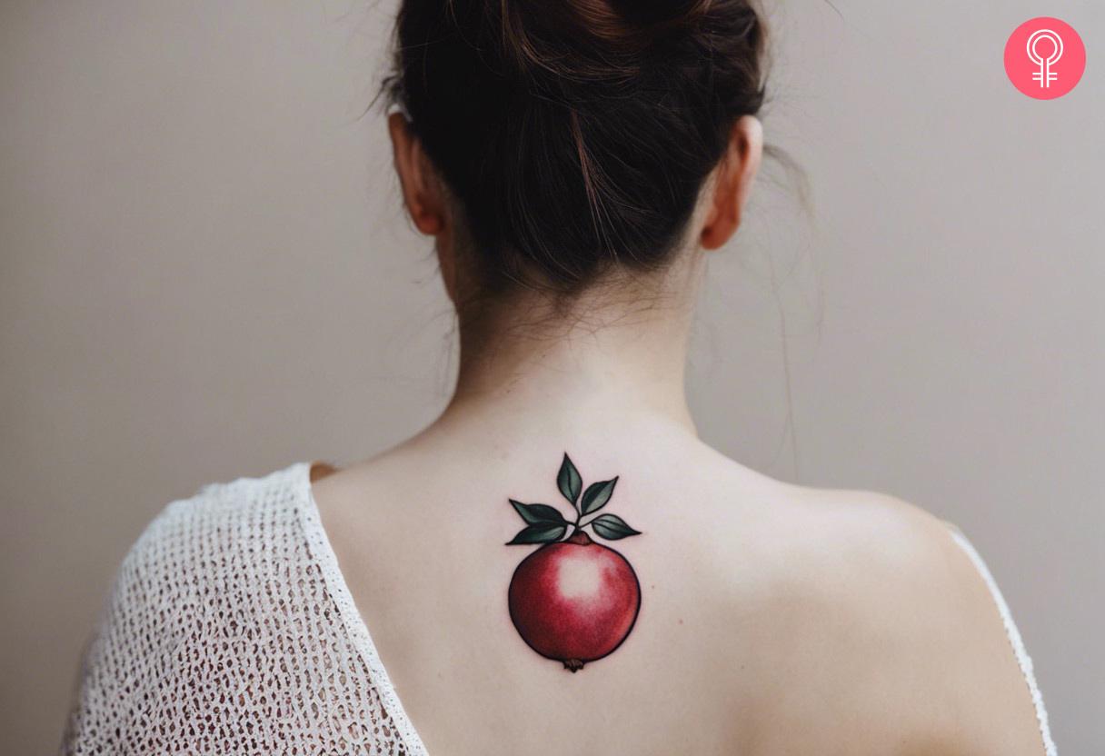 Pomegranate tattoo on a woman's back