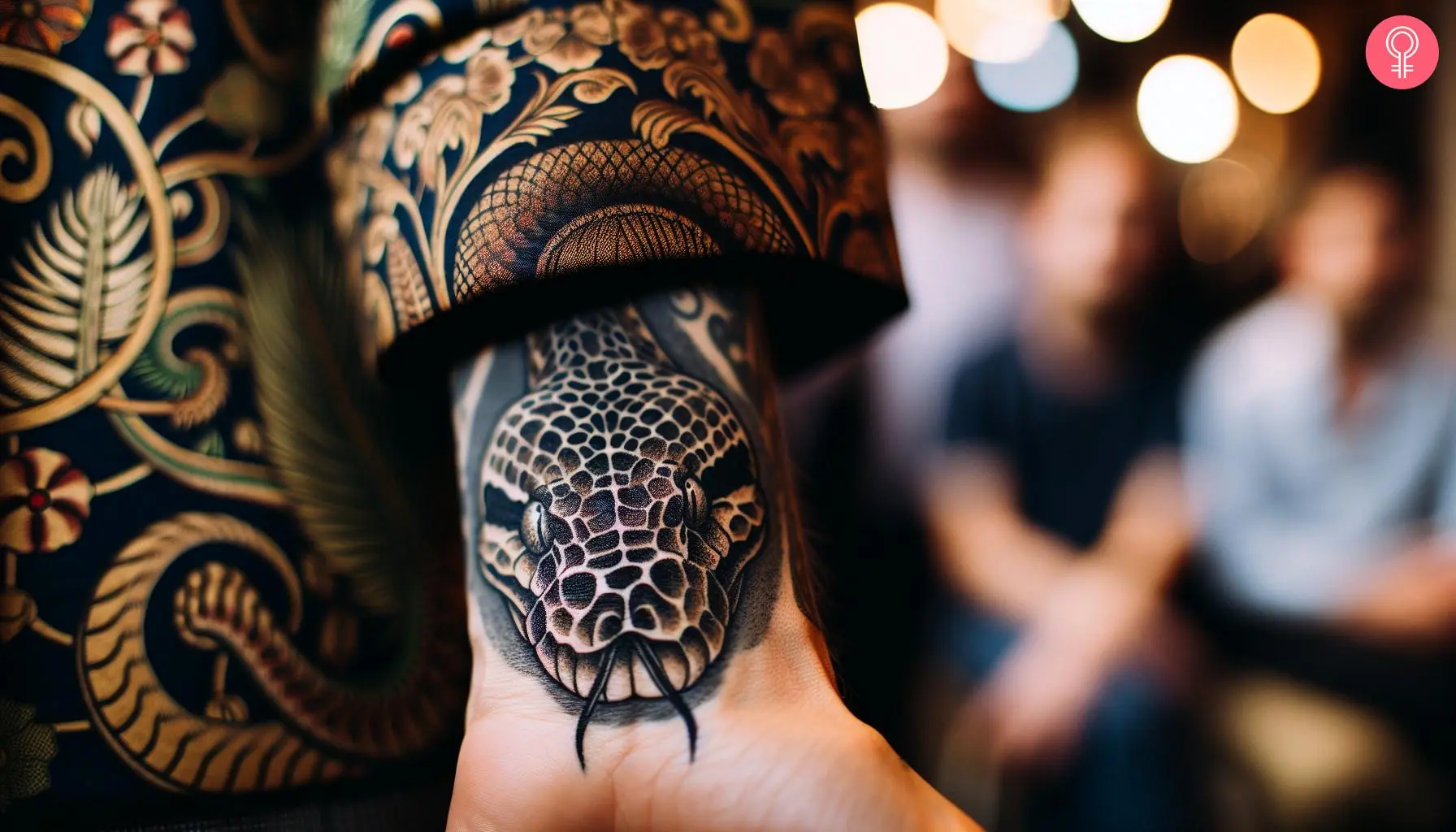 Python head tattoo on the wrist of a man