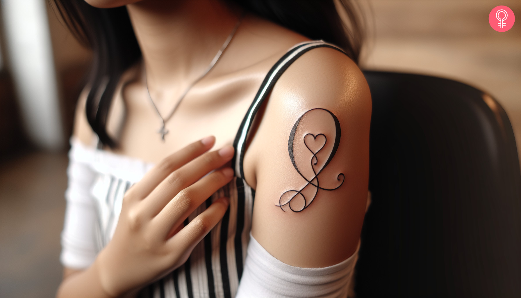 Woman with Q heart tattoo on her arm