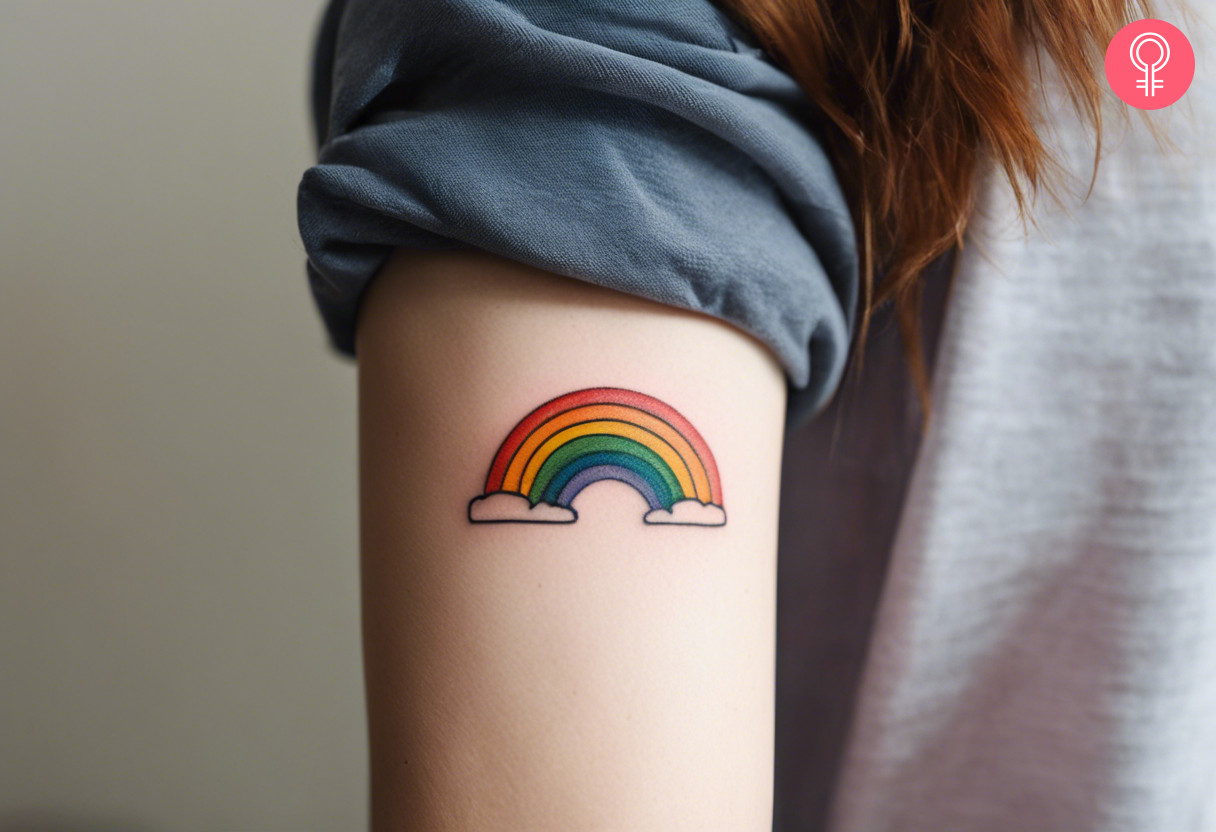 Rainbow new beginning tattoo on the upper arm of a woman