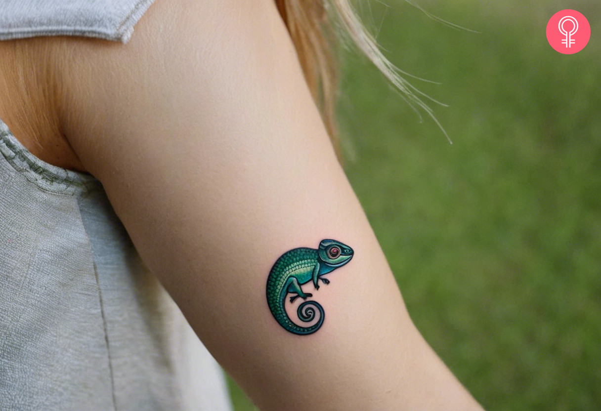 A realistic chameleon tattoo on a woman’s arm