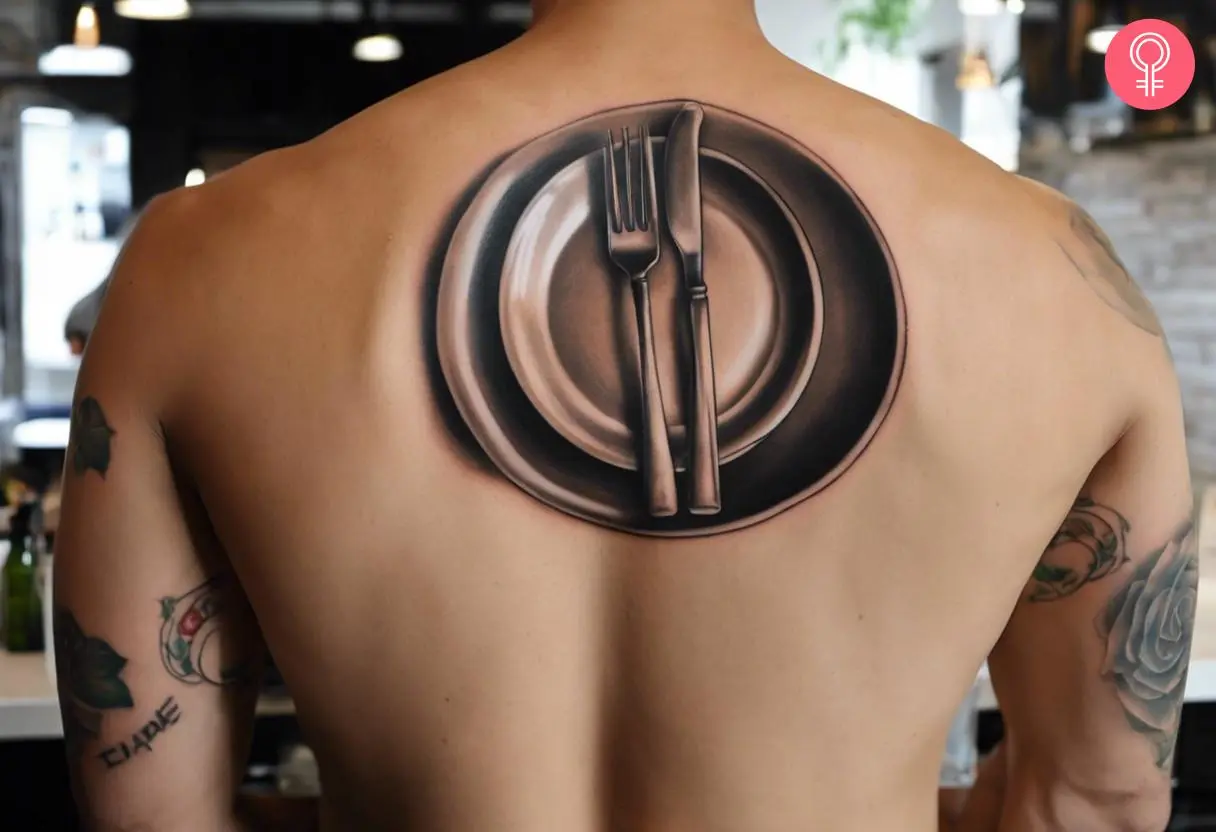 A man wearing a realistic dinner fork tattoo on the upper back