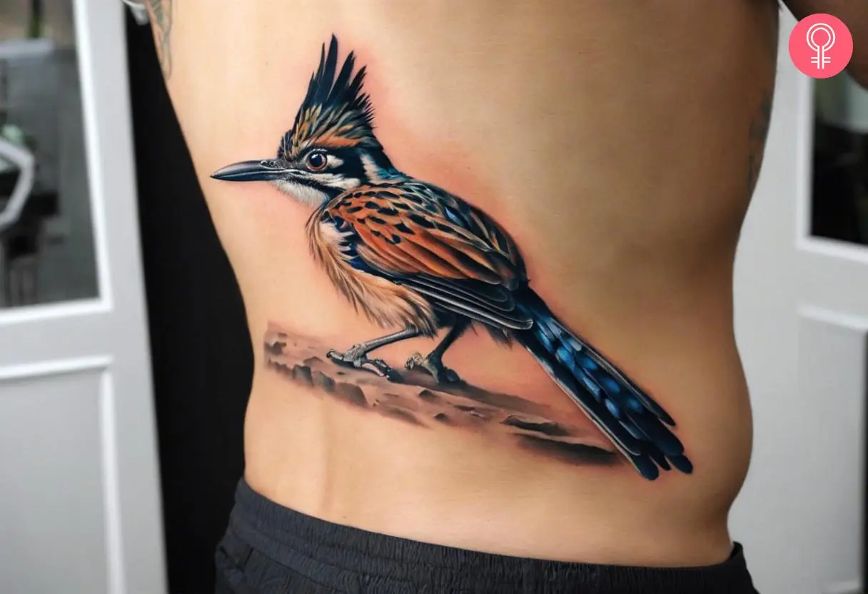 A man wearing a realistic roadrunner tattoo on the lower back.