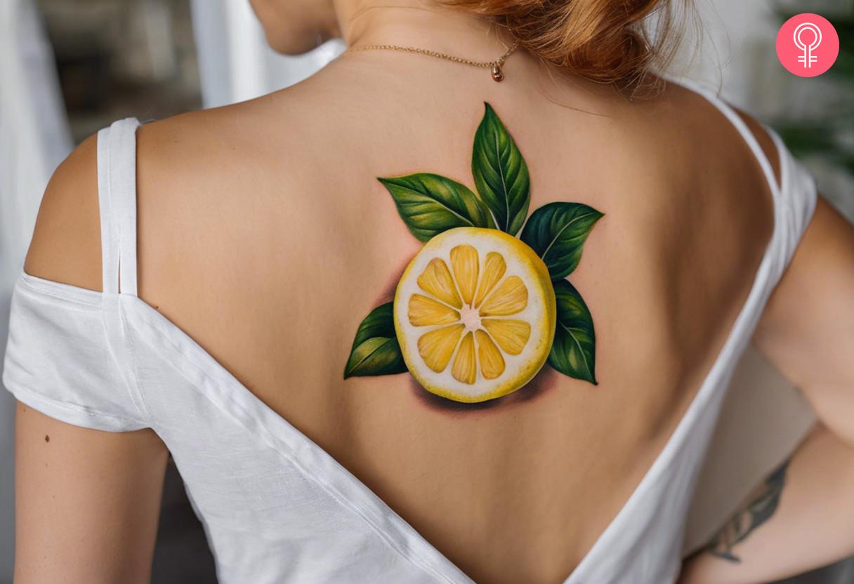 Realistic lemon tattoo on upper back