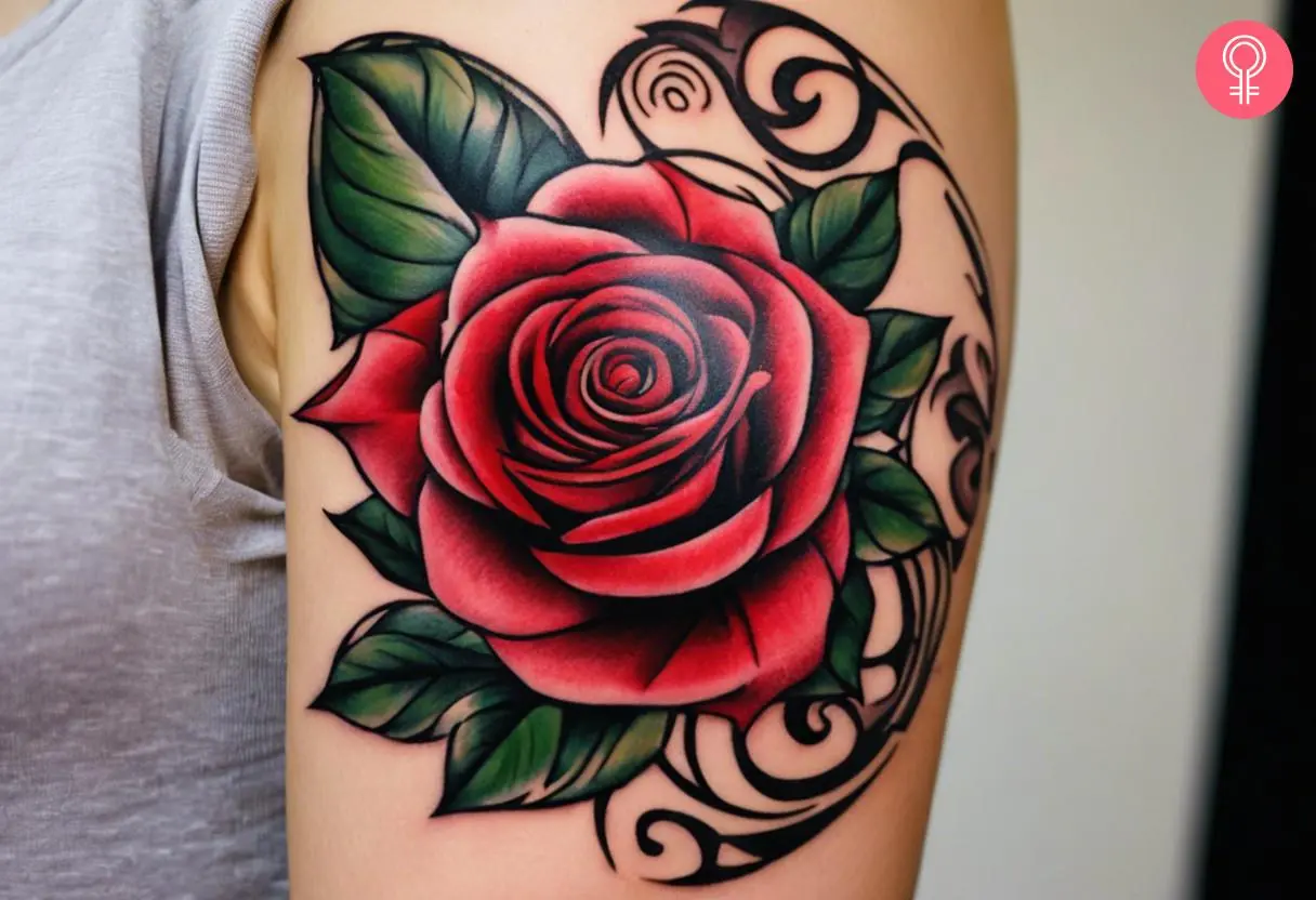 Red rose tribal tattoo on the upper arm of a woman