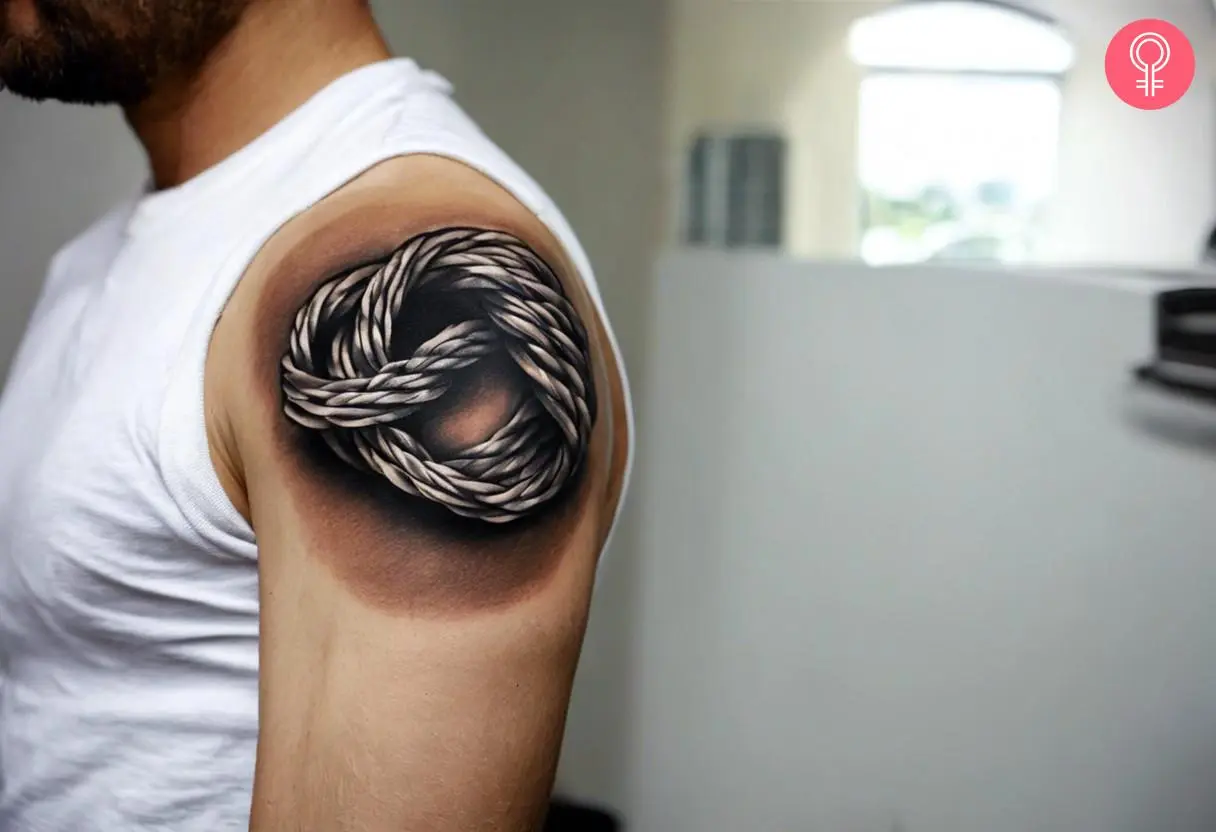 A rope knot tattoo on a man’s upper arm