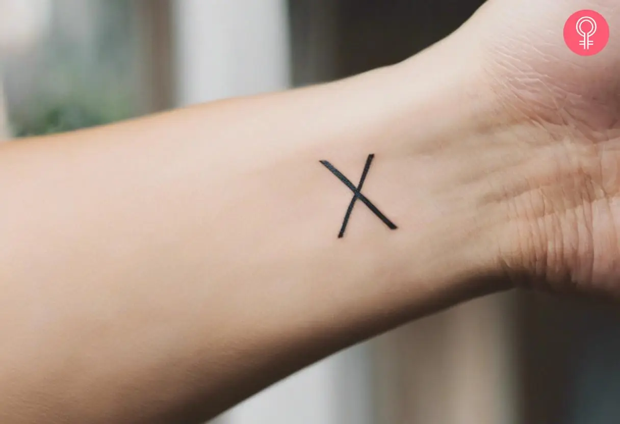 A runic alphabet tattoo on the wrist of a woman