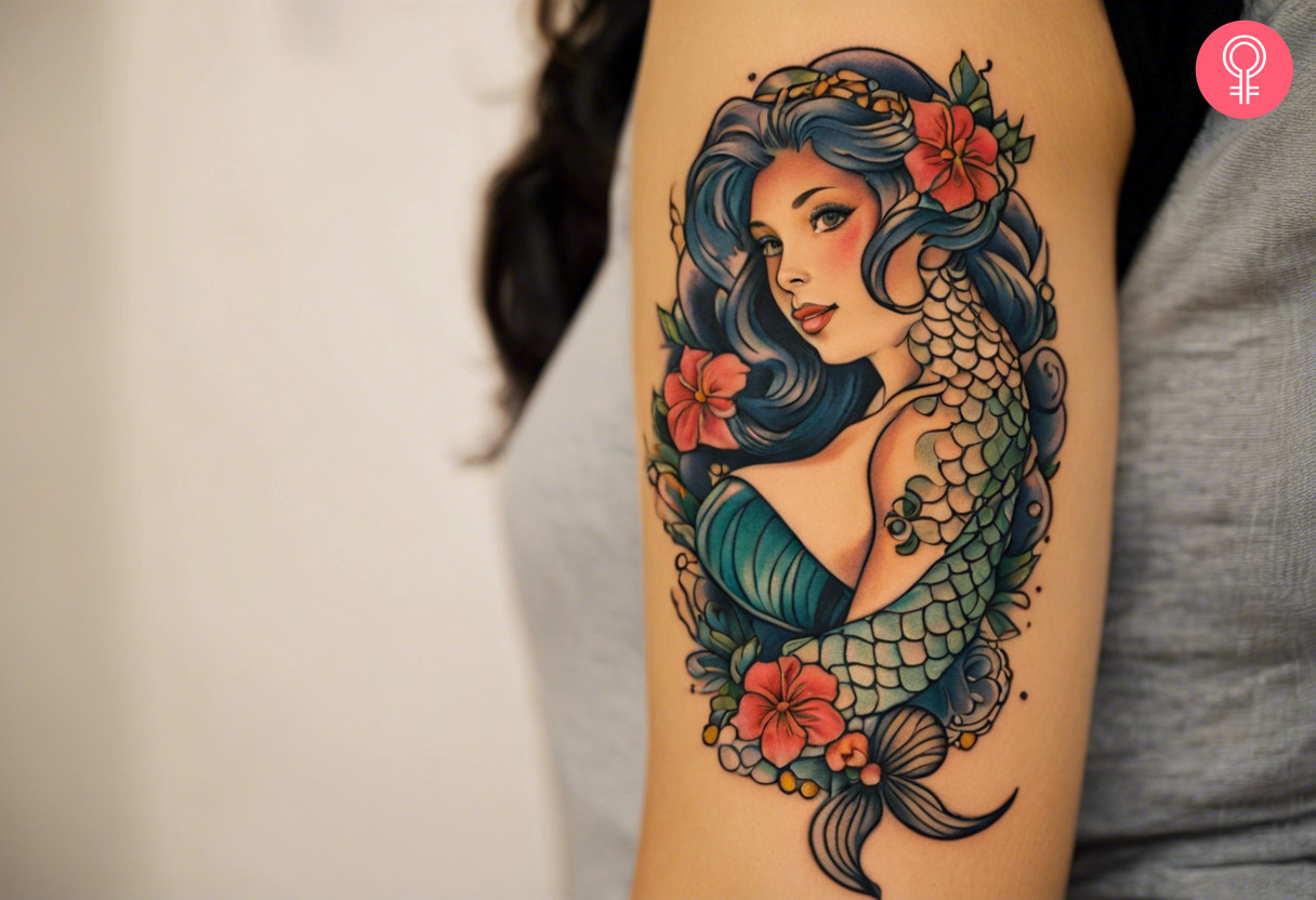 Sacred siren tattoo on the upper arm