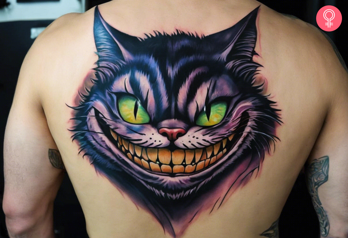 Scary Cheshire cat tattoo on the upper back