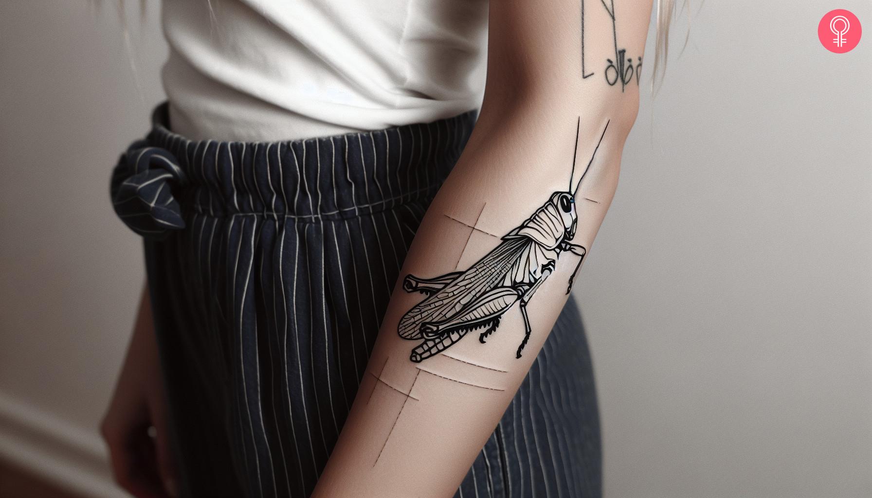 Simple grasshopper tattoo on a woman's forearm