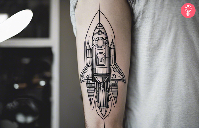 Simple linework spaceship tattoo on the arm