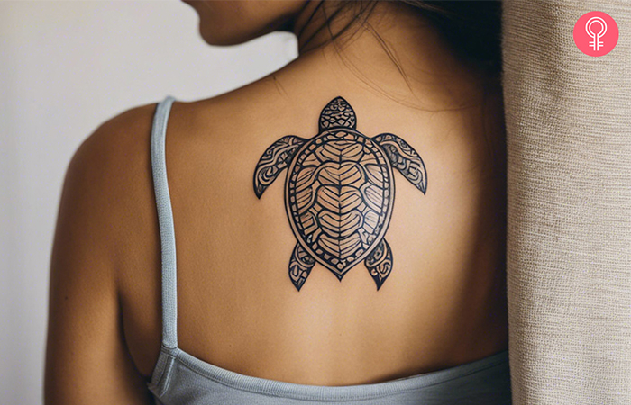 Simple outline tattoo on the arm featuring a Hawaiian turtle
