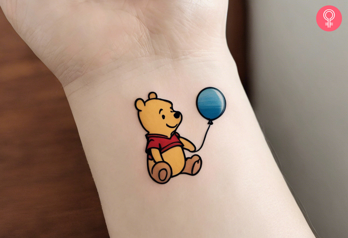 Small winnie the pooh tattoo on the wrist