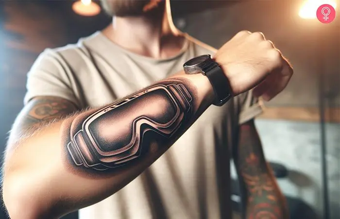 Snowboard goggles tattoo on the forearm of a man