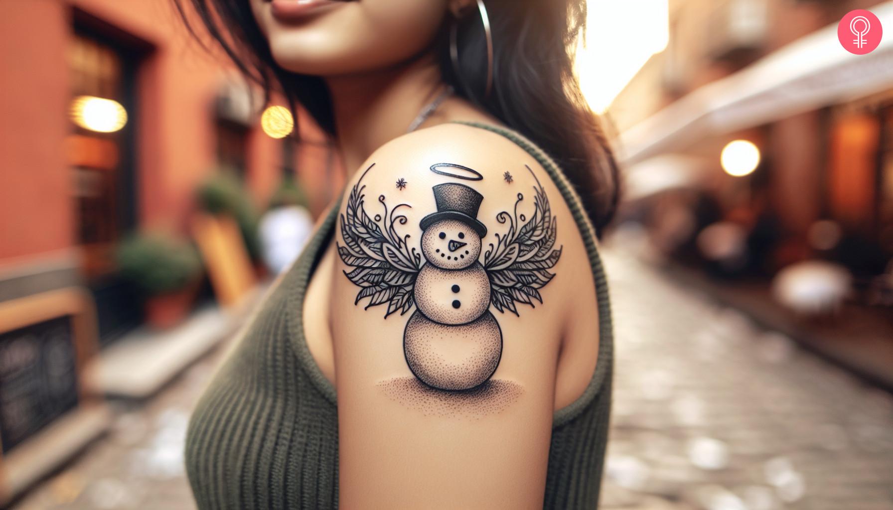 A woman with a snowman angel tattoo on her upper arm