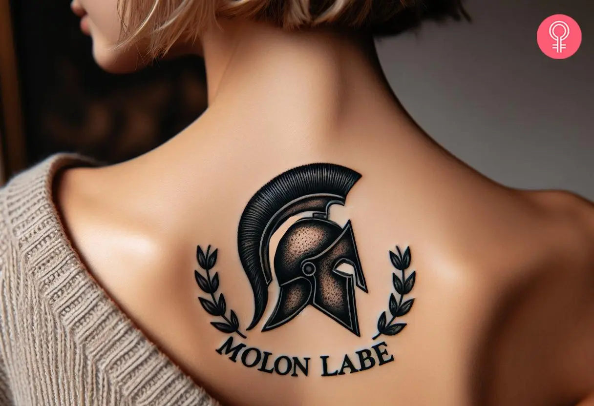 Spartan helmet and ‘molon labe’ tattoo on a woman’s upper back