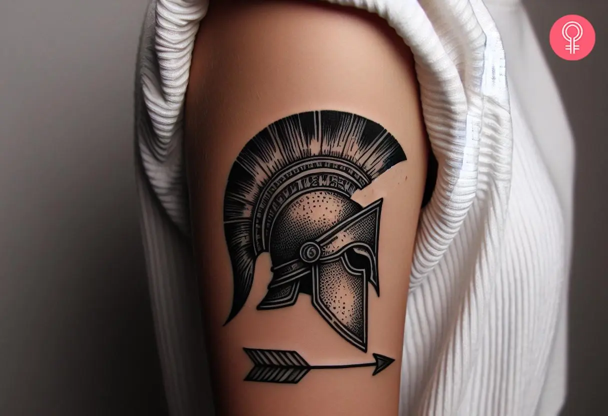 Spartan helmet with arrow tattoo on a woman’s upper arm