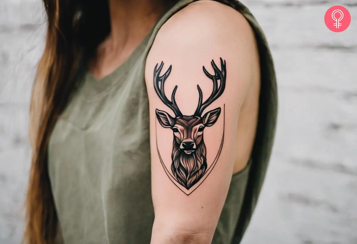 Woman with a stag head tattoo on the upper arm