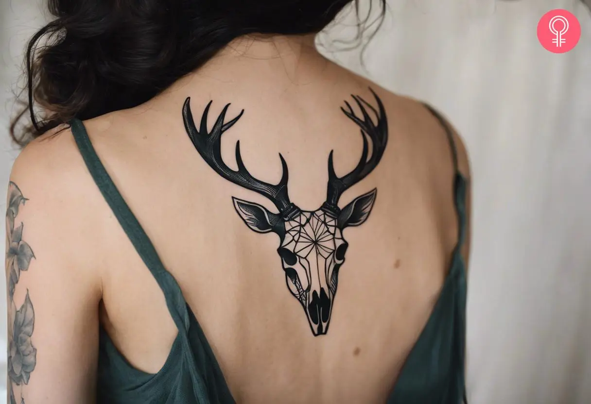 Woman with a stag skull tattoo on the back