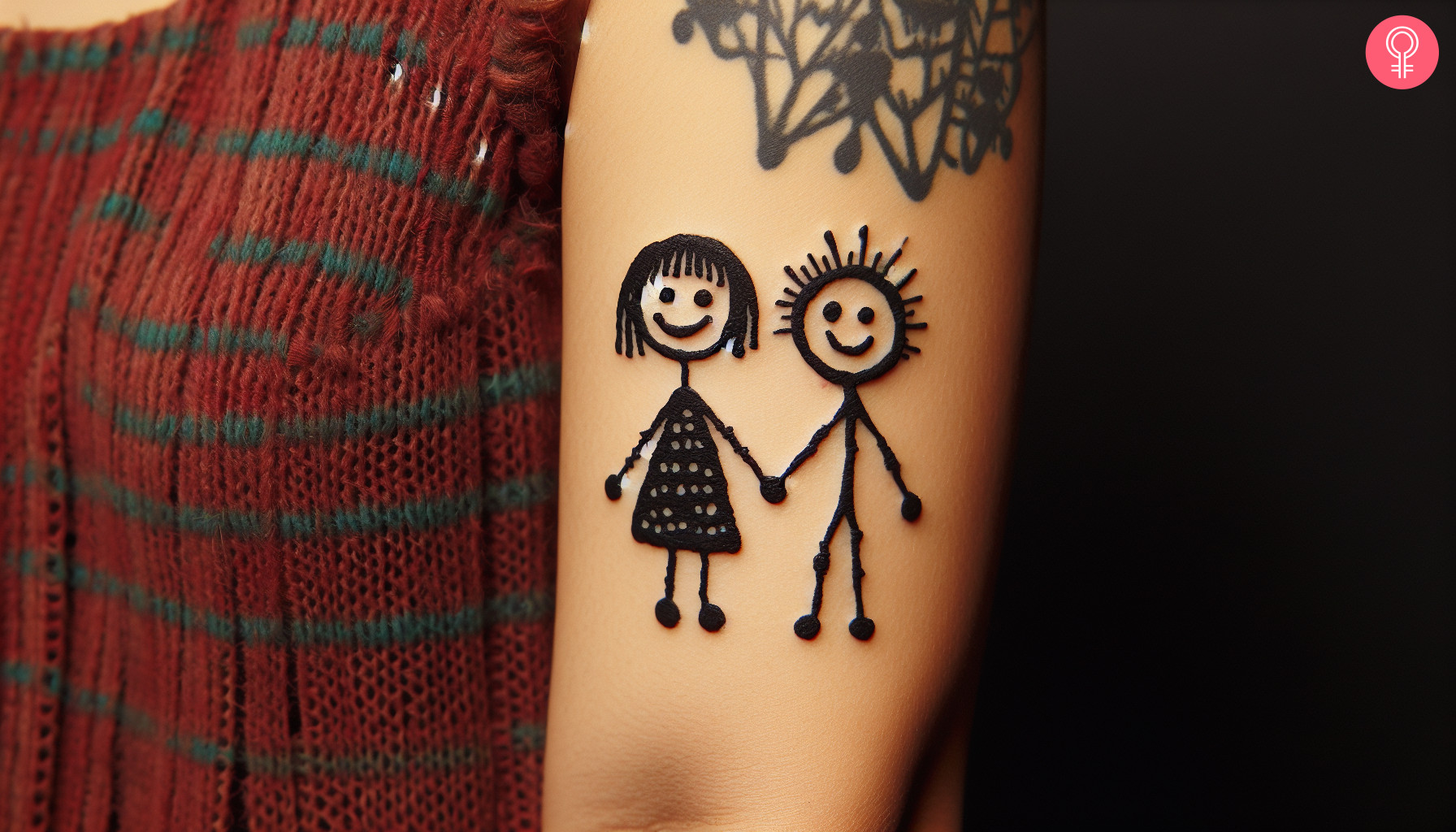 Woman with stick figure couple tattoo on her outer arm