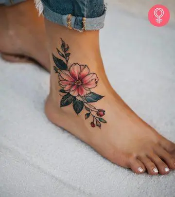 A woman wearing an ankle foot tattoo