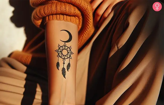 Sun and moon dreamcatcher tattoo on the forearm