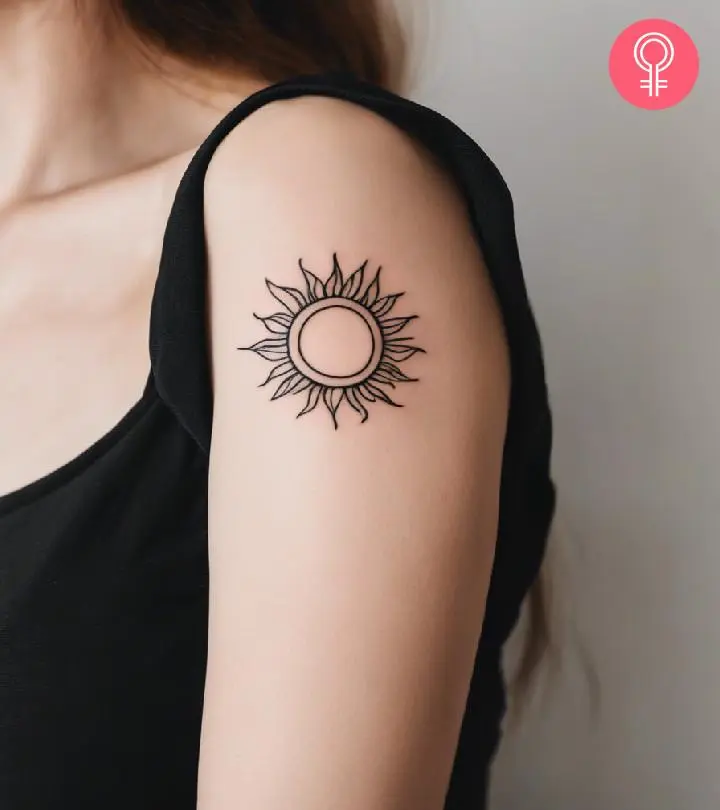 Sun tattoo on the upper arm