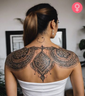 A woman with a floral upper back tattoo