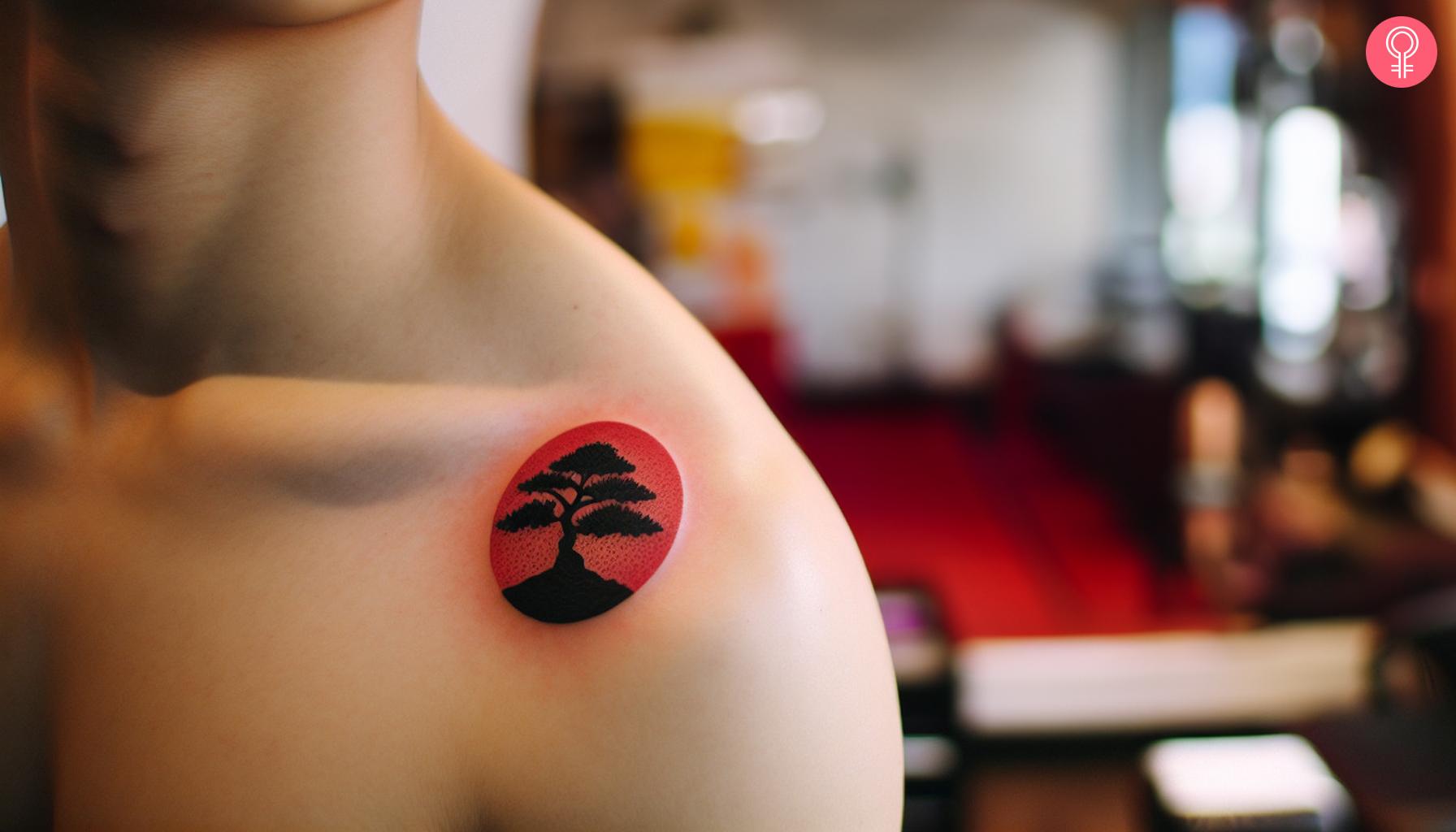 A man with a bonsai tree tattoo on the left shoulder