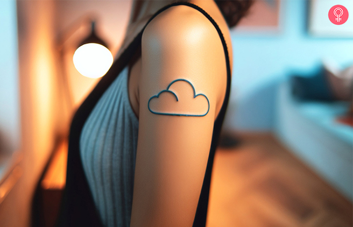 Thin blue line cloud tattoo on the upper arm