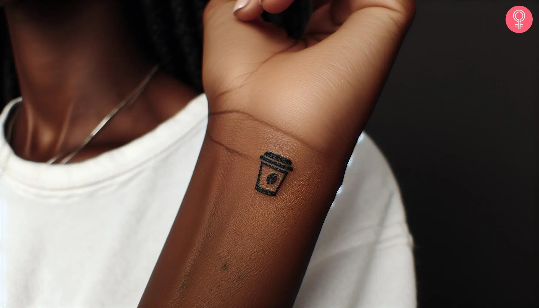 A tiny coffee cup on a woman’s wrist