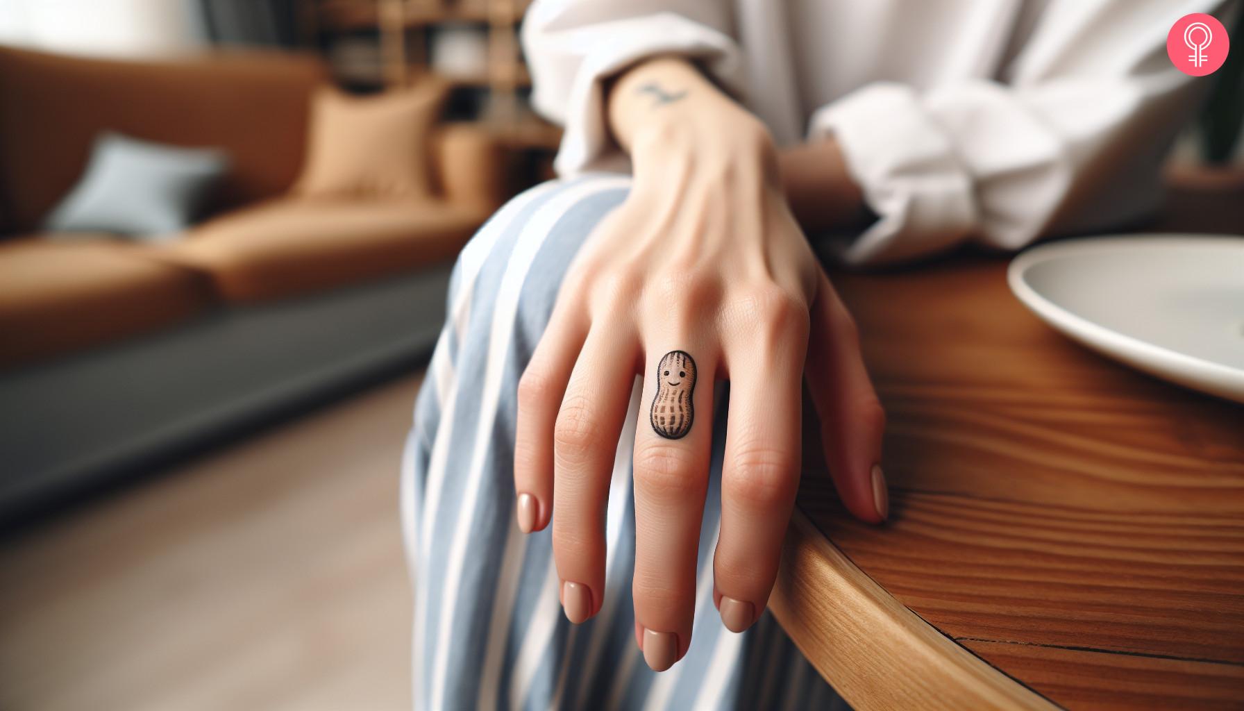 Tiny peanut tattoo on the finger