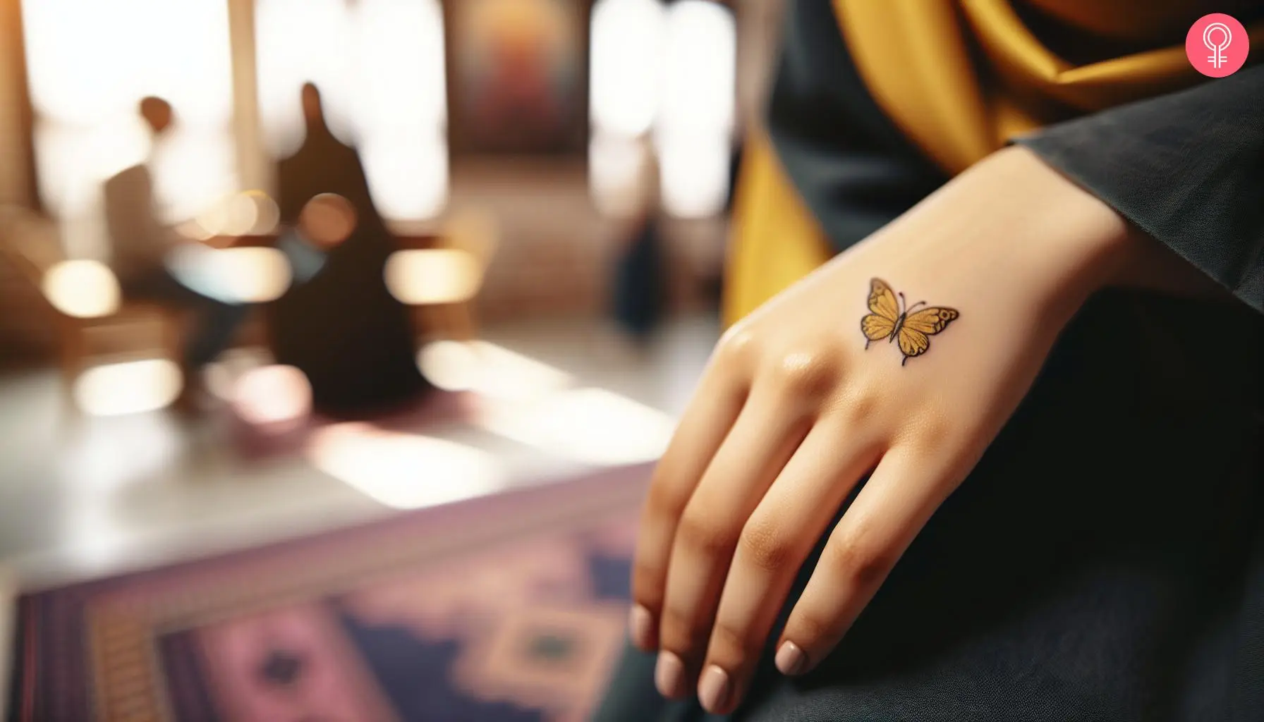 Tiny yellow butterfly tattoo on the hand of a woman