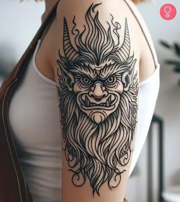 A woman with a Japanese Oni demon tattoo on her upper arm