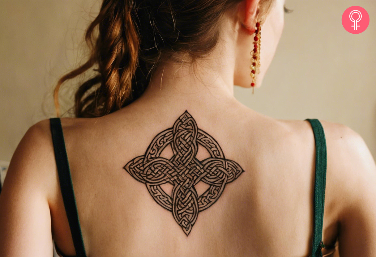 Traditional celtic tattoo on her upper back